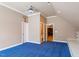 Bright bedroom with interesting architectural features, blue carpet, ceiling fan, and access to a bathroom and other rooms at 113 Kings Castle Dr, Apex, NC 27502