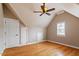Bright bedroom with hardwood floors, a ceiling fan, and windows that let in plenty of natural light at 113 Kings Castle Dr, Apex, NC 27502