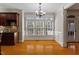 Bright dining area features hardwood floors, large windows, and elegant chandelier at 113 Kings Castle Dr, Apex, NC 27502