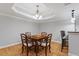 Dining area with chandelier, table and chairs, and hardwood floors at 113 Kings Castle Dr, Apex, NC 27502