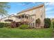 Back exterior view of a multi-story home featuring a deck, a patio, and a well-manicured lawn at 113 Kings Castle Dr, Apex, NC 27502