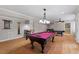 Finished game room features billiard table, hardwood floors, and recessed lighting at 113 Kings Castle Dr, Apex, NC 27502