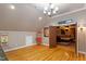 Spacious game room with hardwood floors, adjoining theater room, and vintage concession stand at 113 Kings Castle Dr, Apex, NC 27502