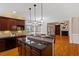 Kitchen with granite countertops, custom cabinetry, and an open layout to the living room at 113 Kings Castle Dr, Apex, NC 27502