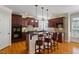 Kitchen features granite countertops, hardwood floors, a breakfast bar, and stainless steel appliances at 113 Kings Castle Dr, Apex, NC 27502
