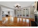 Large living room with hardwood floors, fireplace, and exterior access with glass paneled doors at 113 Kings Castle Dr, Apex, NC 27502