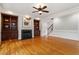 Open living room features a fireplace with built-in shelving and hardwood floors at 113 Kings Castle Dr, Apex, NC 27502