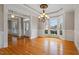 This elegant living room features hardwood floors, wainscoting, and a large bay window at 113 Kings Castle Dr, Apex, NC 27502