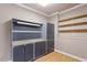 Storage room features slat wall with cabinets, metal cabinets and overhead shelves at 113 Kings Castle Dr, Apex, NC 27502