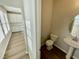 Convenient half bathroom featuring modern fixtures and a pedestal sink, adjacent to the kitchen area at 1200 Alston Landing Way # 05, Cary, NC 27519