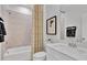 Well-lit bathroom with white vanity, tile backsplash, and bathtub-shower combination at 1200 Alston Landing Way # 05, Cary, NC 27519