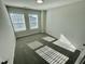Well-lit bedroom with neutral walls, carpeted floor, and large double windows at 1200 Alston Landing Way # 05, Cary, NC 27519