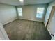 Bright bedroom with two large windows, neutral carpet, and closet at 1200 Alston Landing Way # 05, Cary, NC 27519