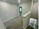 Upstairs hallway featuring carpet flooring and access to all the bedrooms at 1200 Alston Landing Way # 05, Cary, NC 27519