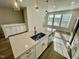 Kitchen island with stainless steel dishwasher, modern faucet, and quartz countertop offers space for cooking and dining at 1200 Alston Landing Way # 05, Cary, NC 27519