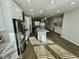 Bright kitchen with stainless steel fridge, center island, and open layout, great for entertaining at 1200 Alston Landing Way # 05, Cary, NC 27519