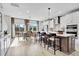 Bright, modern kitchen with a large island, stainless steel appliances, and a view to the outdoor patio at 1200 Alston Landing Way # 05, Cary, NC 27519