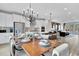 Open kitchen with stainless appliances and island, seamlessly connected to a dining area and living space at 1200 Alston Landing Way # 05, Cary, NC 27519