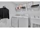 Functional laundry room with washer, dryer, sink, and organized shelving at 1200 Alston Landing Way # 05, Cary, NC 27519