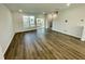 Spacious living room with hardwood floors, large windows, and sliding glass door to the outside deck at 1200 Alston Landing Way # 05, Cary, NC 27519