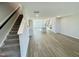 Open-concept living space with hardwood floors, staircase, and easy access to the kitchen at 1200 Alston Landing Way # 05, Cary, NC 27519