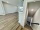 Open-concept living room with hardwood floors and staircase to basement at 1200 Alston Landing Way # 05, Cary, NC 27519