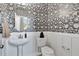 Elegant powder room featuring black and white floral wallpaper and a pedestal sink with modern fixtures at 1202 Alston Landing Way # 06, Cary, NC 27519