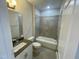 Well-lit bathroom featuring a shower-tub combo with tiled walls and a modern vanity with a gray countertop at 1202 Alston Landing Way # 06, Cary, NC 27519