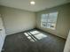 Bright bedroom with carpet floors, a large window with blinds, and a neutral color scheme for a serene atmosphere at 1202 Alston Landing Way # 06, Cary, NC 27519