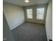 Bedroom featuring neutral walls, carpet floors, two windows with blinds allowing natural light in at 1202 Alston Landing Way # 06, Cary, NC 27519