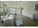 Bright, spacious kitchen featuring a center island, stainless steel appliances, and ample cabinet space at 1202 Alston Landing Way # 06, Cary, NC 27519