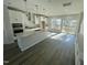 Modern, bright kitchen with white cabinets, central island, and stainless steel appliances at 1202 Alston Landing Way # 06, Cary, NC 27519