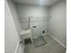 Laundry room featuring utility sink, grey floors, and plenty of space for washer and dryer at 1202 Alston Landing Way # 06, Cary, NC 27519