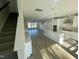 Spacious living room featuring wood floors, stairs, and an open layout leading into a kitchen at 1202 Alston Landing Way # 06, Cary, NC 27519
