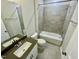 Modern bathroom featuring a tiled shower-tub, large mirror, and sleek vanity with a sink at 1206 Alston Landing Way # 08, Cary, NC 27519
