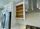 Modern kitchen featuring white cabinets, stainless steel appliances, and a sleek range hood at 1206 Alston Landing Way # 08, Cary, NC 27519