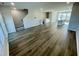 Spacious open-concept living room with hardwood floors, stairs, and leading into kitchen area at 1206 Alston Landing Way # 08, Cary, NC 27519