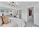 Bright main bedroom featuring an elegant chandelier, lots of light and an open door to the hallway at 1206 Alston Landing Way # 08, Cary, NC 27519