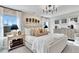 Bright main bedroom with large windows, modern chandelier, textured accent wall, and stylish furnishings at 1206 Alston Landing Way # 08, Cary, NC 27519
