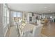 Dining area with a long table, plenty of natural light, and a view into the kitchen at 1234 Coach Station Alley # 201, Raleigh, NC 27601