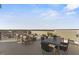 A spacious outdoor patio featuring stylish lounge seating, dining table, and scenic neighborhood views at 1234 Coach Station Alley # 201, Raleigh, NC 27601