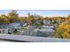 Charming neighborhood street view with well-maintained homes, mature trees, and a glimpse of the city skyline at 1234 Coach Station Alley # 201, Raleigh, NC 27601
