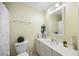 Bright bathroom featuring a wide mirror, vanity with sink, and a toilet at 1303 Dylan Heath Ct, Raleigh, NC 27608