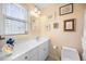 Bright bathroom with a clean sink, mirror, and a toilet at 1303 Dylan Heath Ct, Raleigh, NC 27608