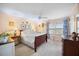 Charming bedroom with carpet, a ceiling fan, and a beautiful side table with a decorative lamp at 1303 Dylan Heath Ct, Raleigh, NC 27608