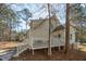 The back exterior view reveals a spacious deck and home design nestled among mature trees, offering a serene, private setting at 138 Sherwood Ln, Sanford, NC 27332