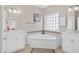 Bright bathroom with corner tub, dual sinks, and ample natural light at 138 Sherwood Ln, Sanford, NC 27332