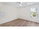Bright bedroom features a ceiling fan, wood-look flooring, and natural light from a window at 138 Sherwood Ln, Sanford, NC 27332