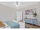 Cozy bedroom with ceiling fan, an adjacent full bathroom, and wood flooring at 138 Sherwood Ln, Sanford, NC 27332