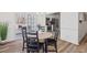 Open-concept dining area leading to the kitchen and backyard deck at 138 Sherwood Ln, Sanford, NC 27332